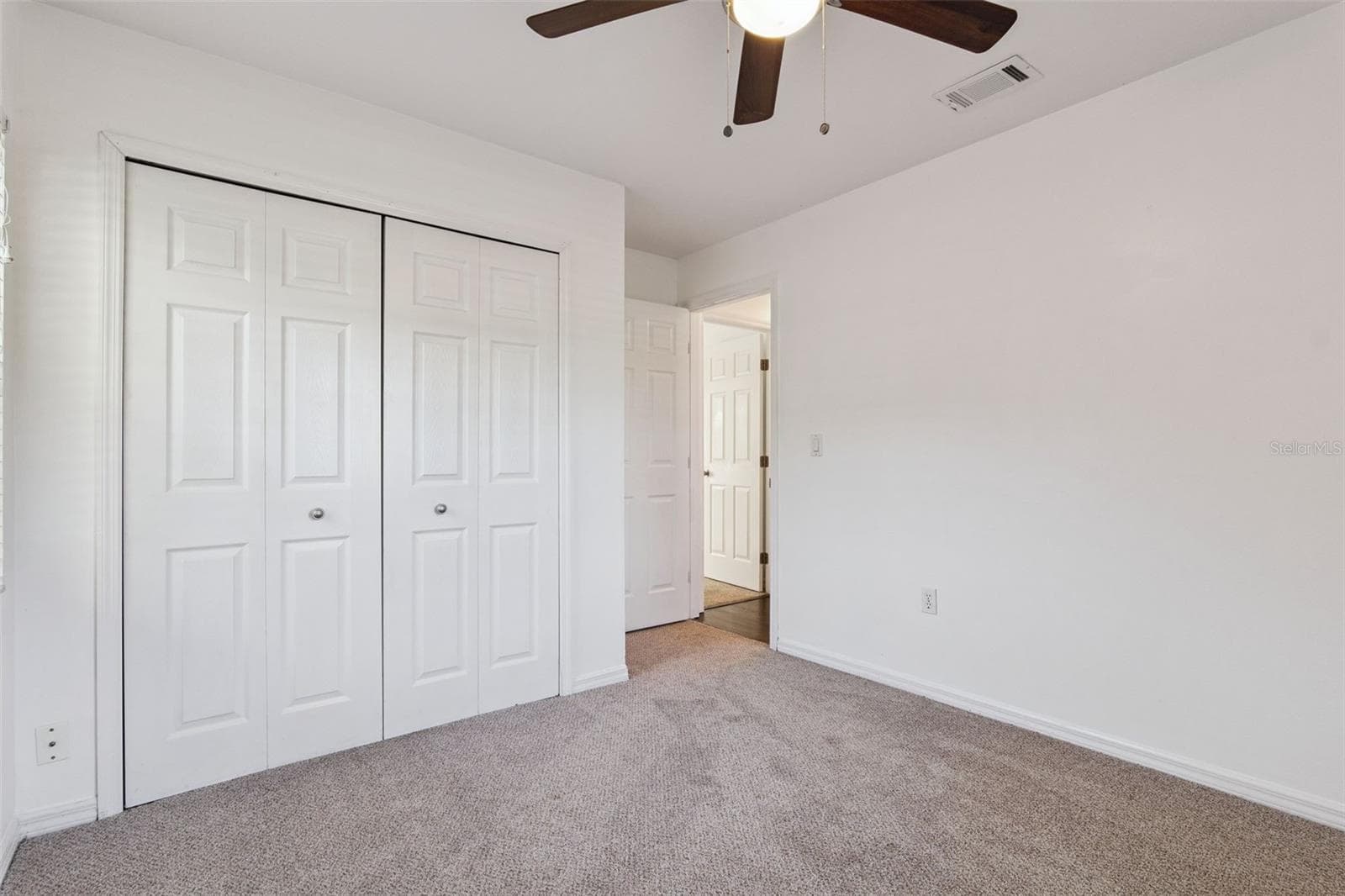 Comfortable bedroom with plush carpet - 5246 ROYAL OAK DR, FRUITLAND PARK