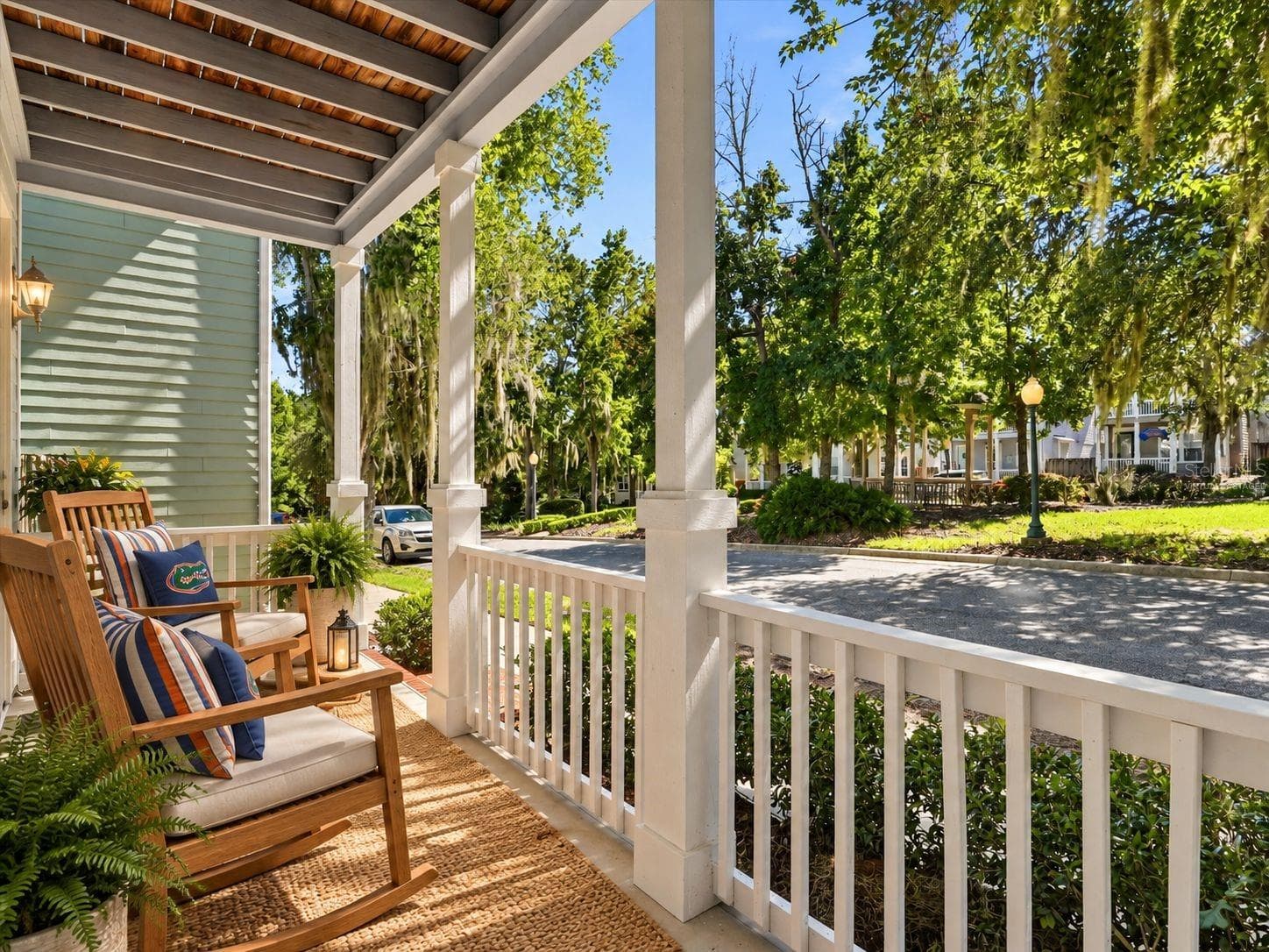 Virtually Staged - Front Porch with rocking chairs under a shade tree. - 11644 NW 18TH PL, GAINESVILLE