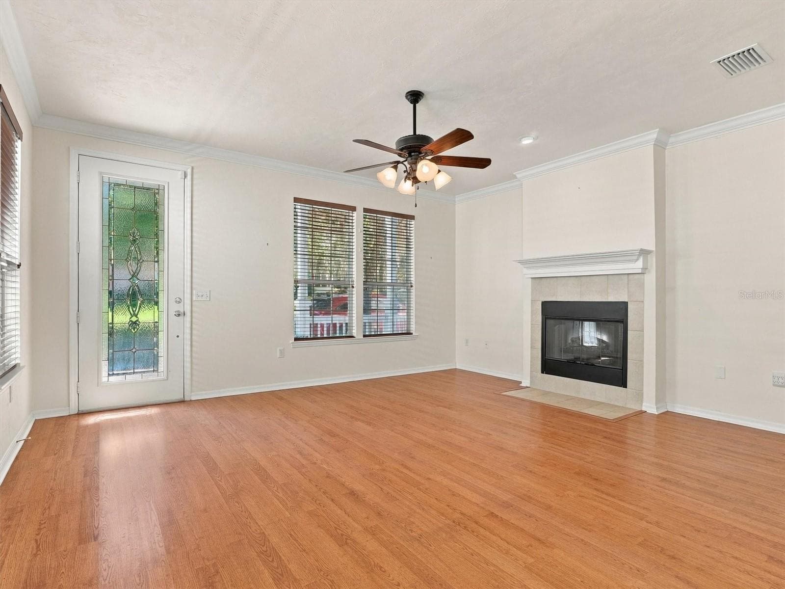 Living Room with beautiful front door, fireplace and ceiling fans. - 11644 NW 18TH PL, GAINESVILLE