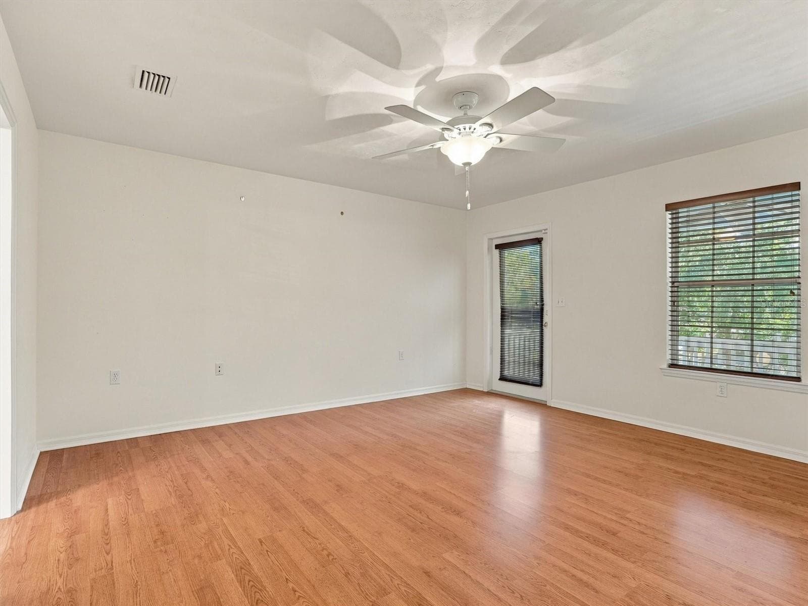 Primary Bedroom with Door to Balcony Porch, Dual Closets, En-Suite Bathroom - 11644 NW 18TH PL, GAINESVILLE