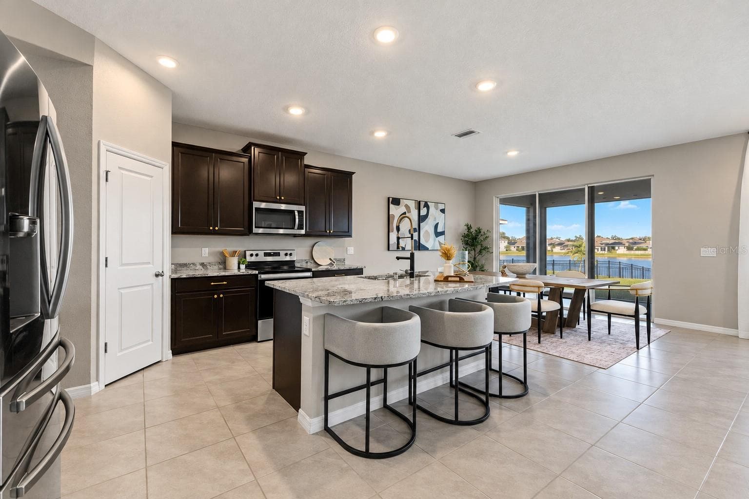 Kitchen island and dining connection - 5126 Jackel Chase Dr, Wimauma - 5126 JACKEL CHASE DR, WIMAUMA