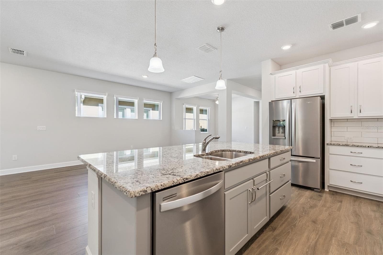 Kitchen with stainless appliances, pull out drawers, subway tile backsplash, and plenty of light - 6103 PLOVER MEADOW ST, LITHIA