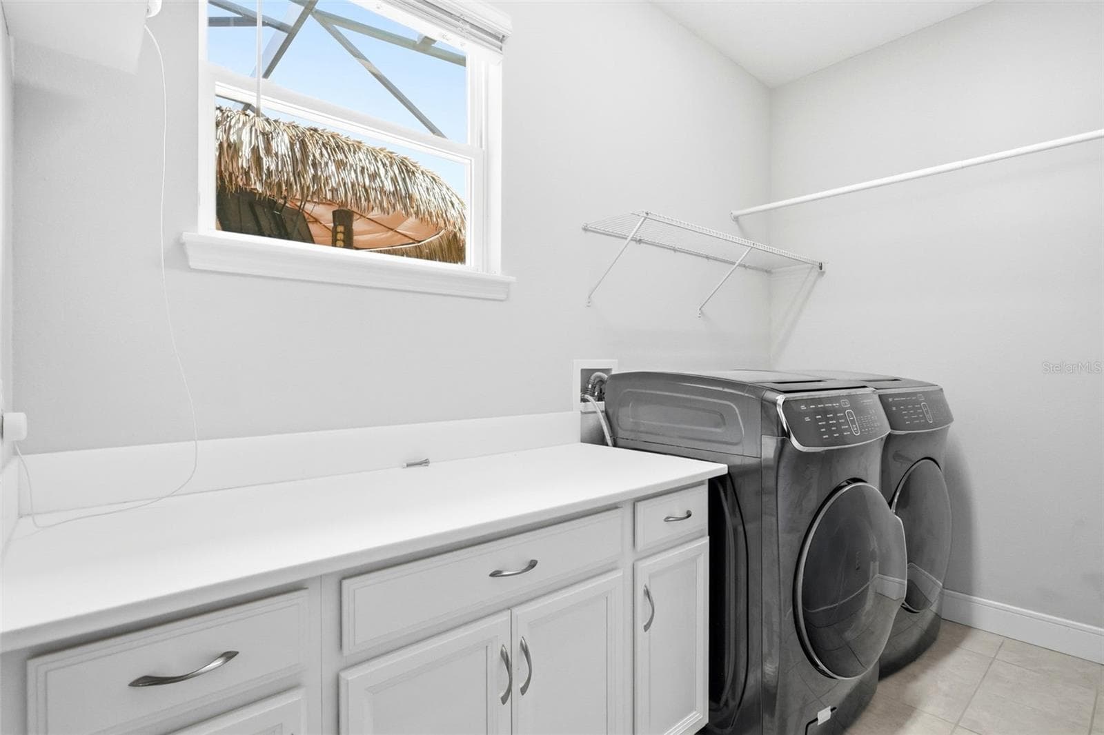 Laundry room features cabinet and counter space along with a washer and dryer - 1552 MYRTLE OAKS TRL, OVIEDO