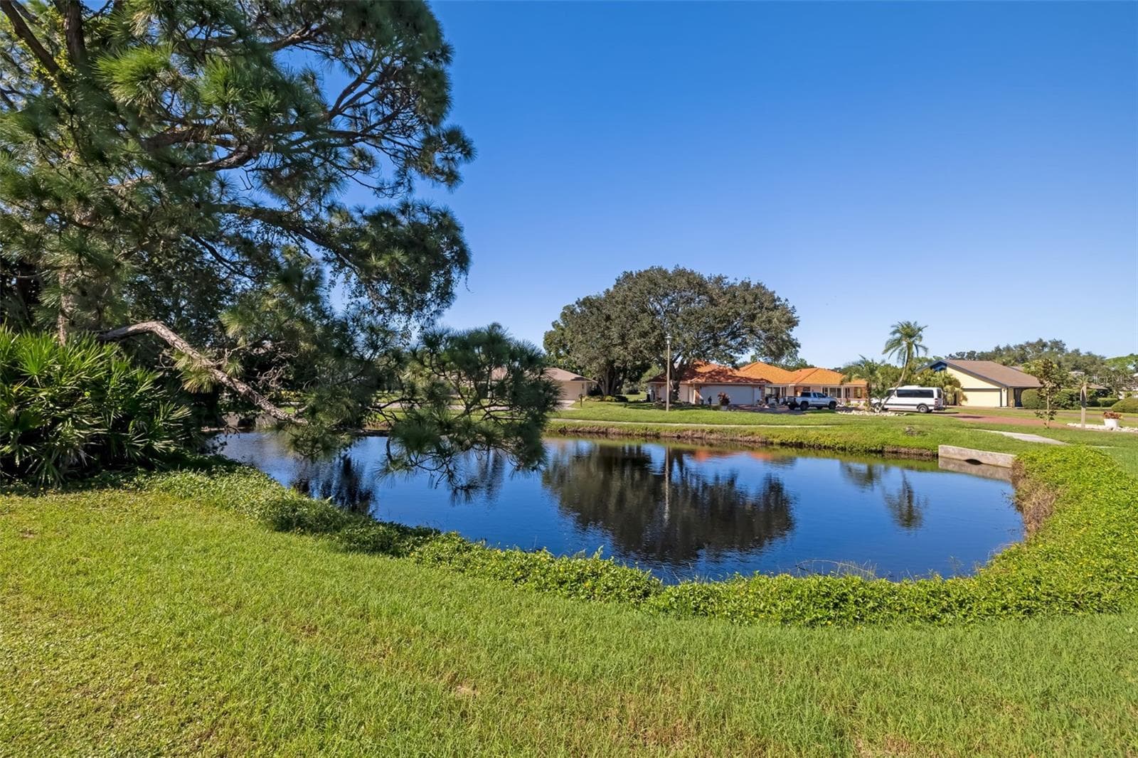 Serene pond along the side of the home, a peaceful water view. - 3065 RINGWOOD MDW, SARASOTA