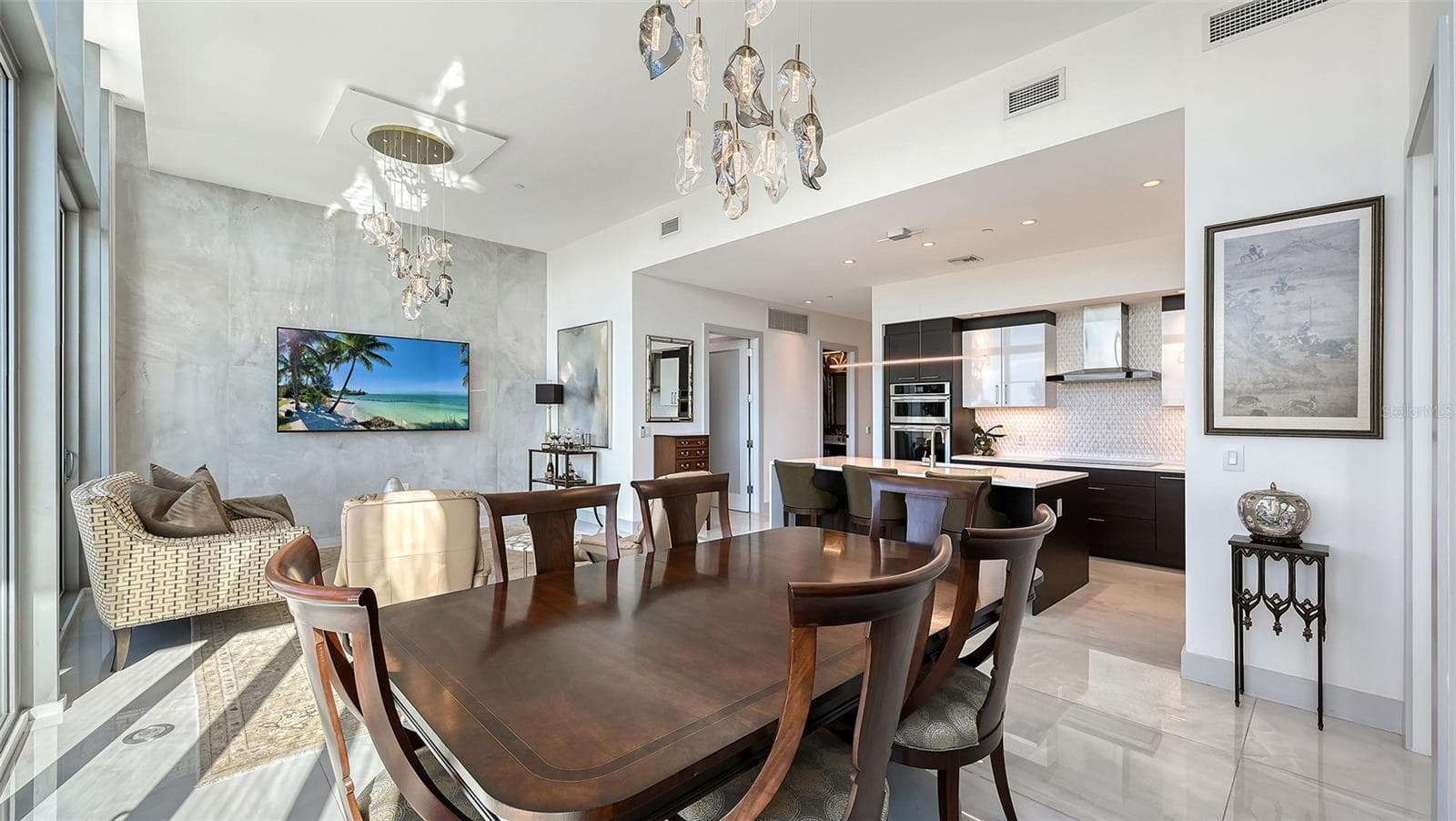 An inviting dining area seamlessly connected to the kitchen and living room, perfect for memorable meals, lively game nights, and effortless entertaining. - 1155 N GULFSTREAM AVE #207, SARASOTA