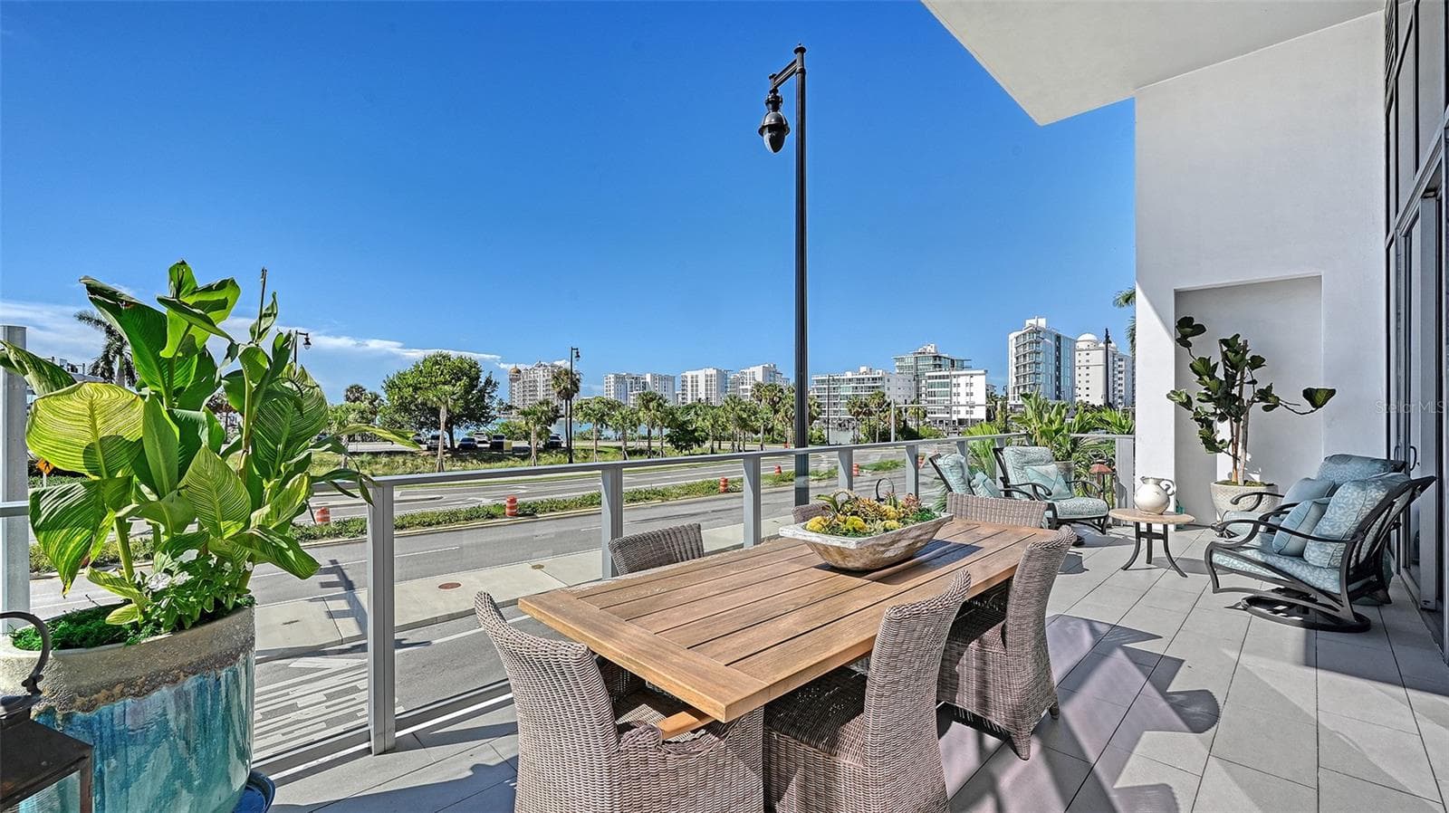 Enjoy elegant outdoor entertaining on the expansive private terrace, perfect for al fresco dining while taking in the beautiful marina views and passing boats. - 1155 N GULFSTREAM AVE #207, SARASOTA