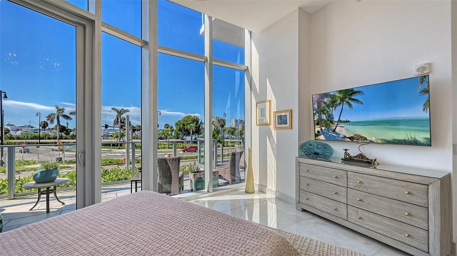 A light-filled primary suite with soaring ceilings, elegant finishes, and a serene, airy ambiance. - 1155 N GULFSTREAM AVE #207, SARASOTA