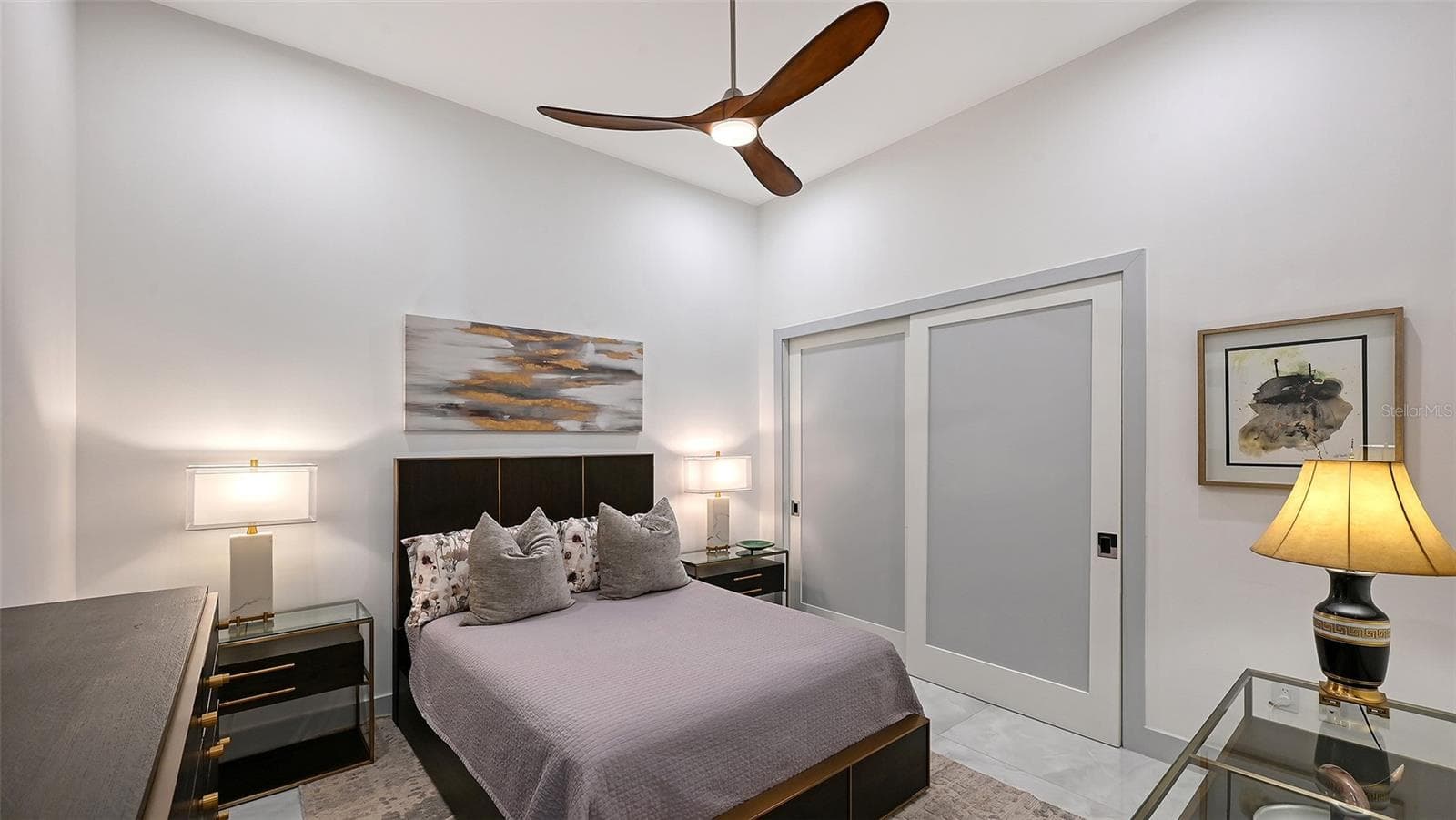 A generous second bedroom featuring custom-designed closets and refined comfort. - 1155 N GULFSTREAM AVE #207, SARASOTA