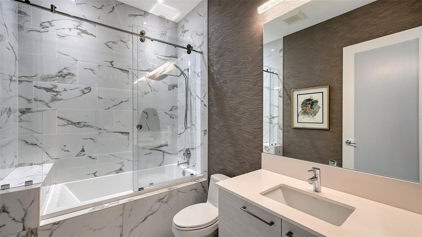 A luxurious, oversized walk-in shower enclosed in sleek glass, offering a spa-inspired bathing experience. - 1155 N GULFSTREAM AVE #207, SARASOTA