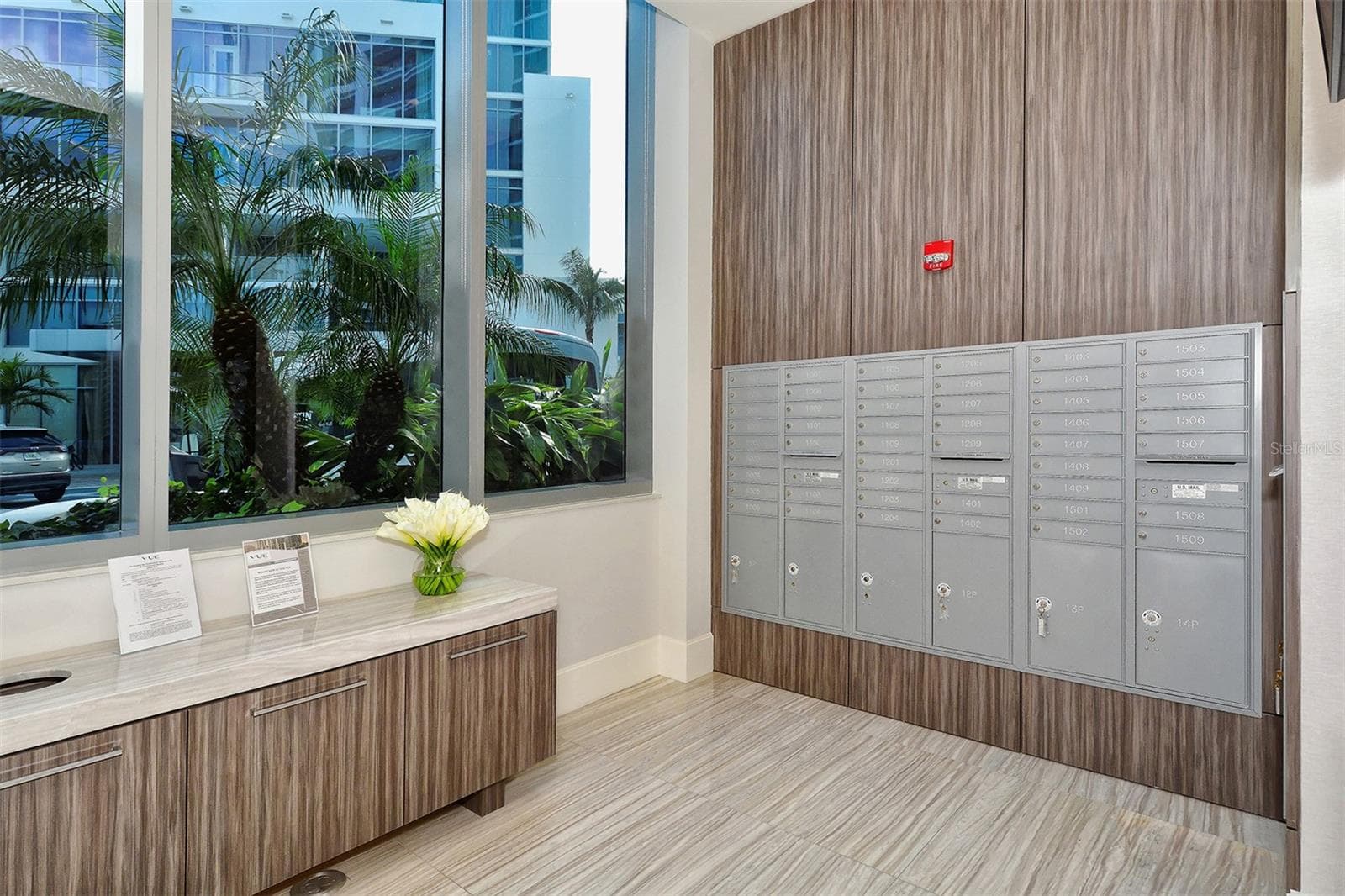 A dedicated resident mailbox area featuring a digital display with upcoming community events and announcements for added convenience. - 1155 N GULFSTREAM AVE #207, SARASOTA