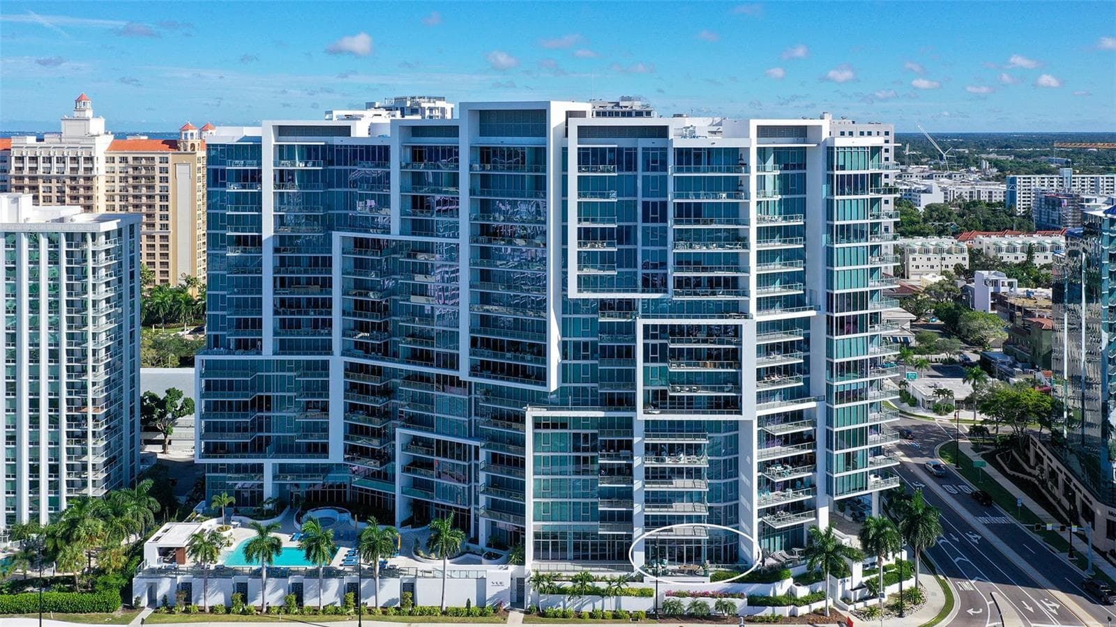 An aerial perspective highlights The VUE’s iconic architecture, showcasing its distinctive lines, elegant contours, and striking modern design. - 1155 N GULFSTREAM AVE #207, SARASOTA