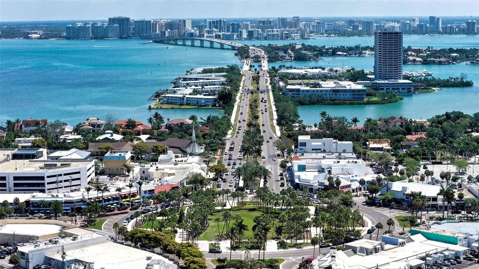 A stunning aerial perspective from St. Armands Circle toward downtown Sarasota, showcasing the iconic skyline framed by sparkling Bay waters. - 1155 N GULFSTREAM AVE #207, SARASOTA