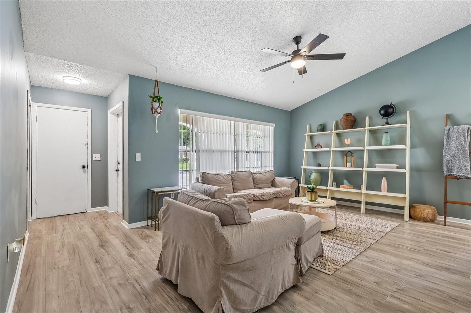 As you enter your new abode, you have a lovely living space with a neutral but bold paint color - 1332 BOREAS DR, ORLANDO