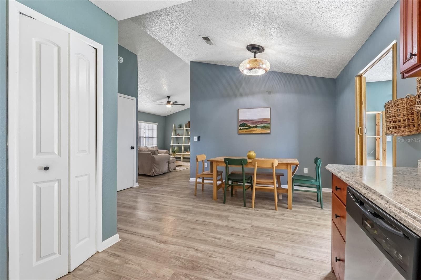 View from the kitchen to the dining room and you have an updated modern light fixture - 1332 BOREAS DR, ORLANDO