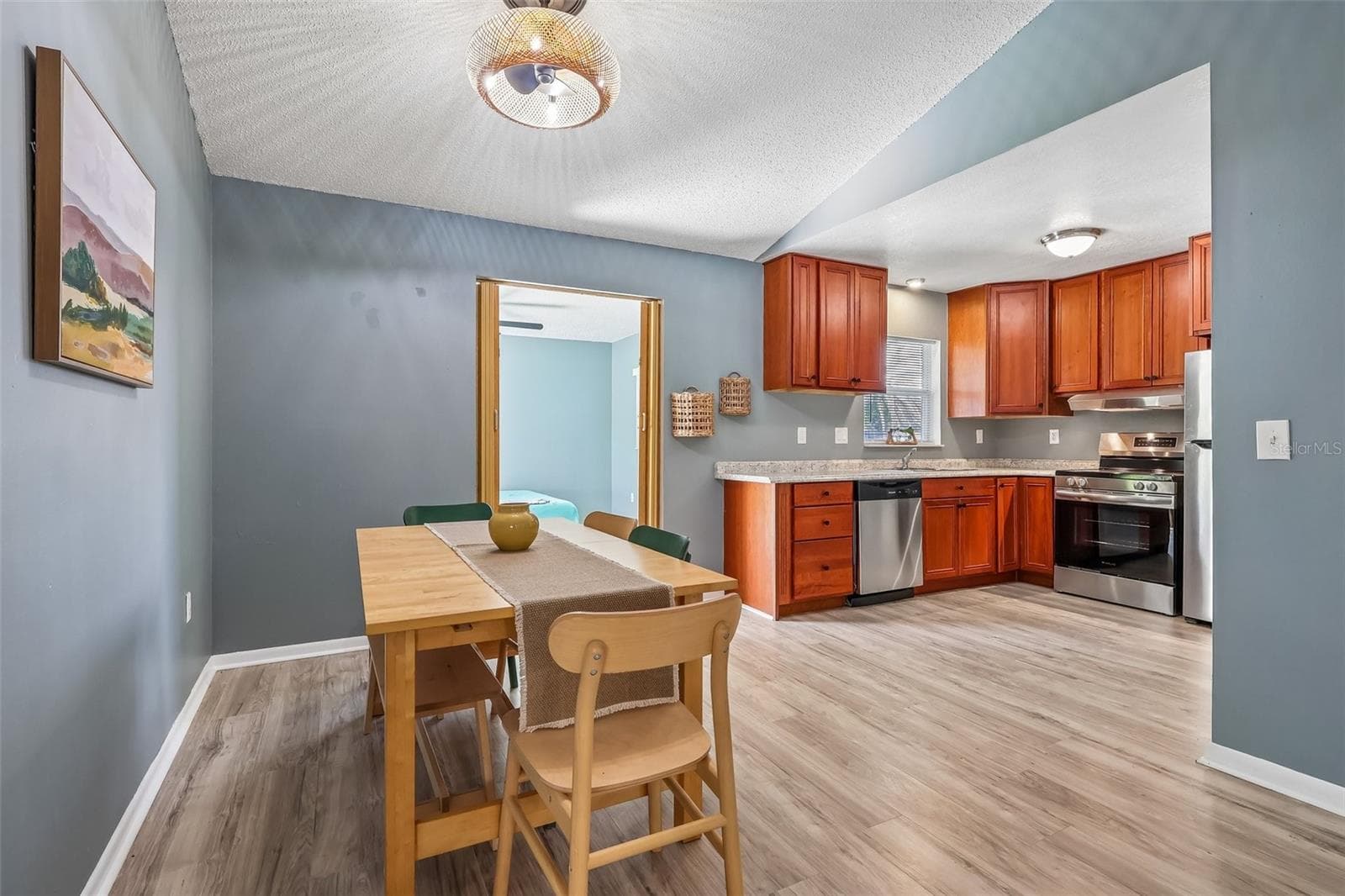 The dining room opens up to the kitchen for enjoying meals with friends and family and easy hosting - 1332 BOREAS DR, ORLANDO