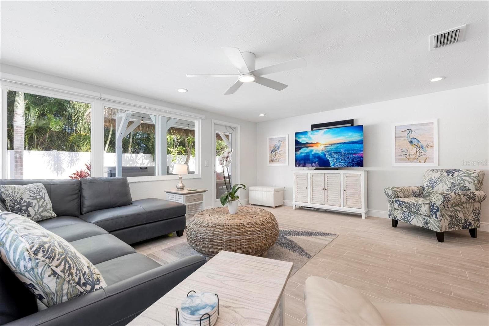 Open concept living area with access to the heated pool and tikki covered pergola - 504 69TH ST, HOLMES BEACH