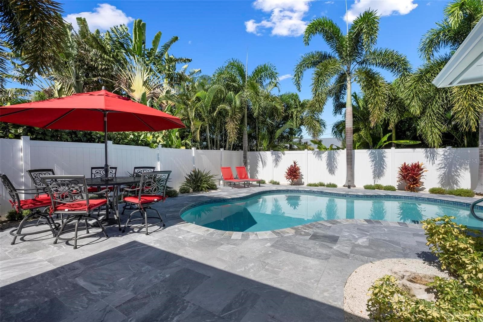 Pavered outdoor pool patio with heated saltwater pool - 504 69TH ST, HOLMES BEACH