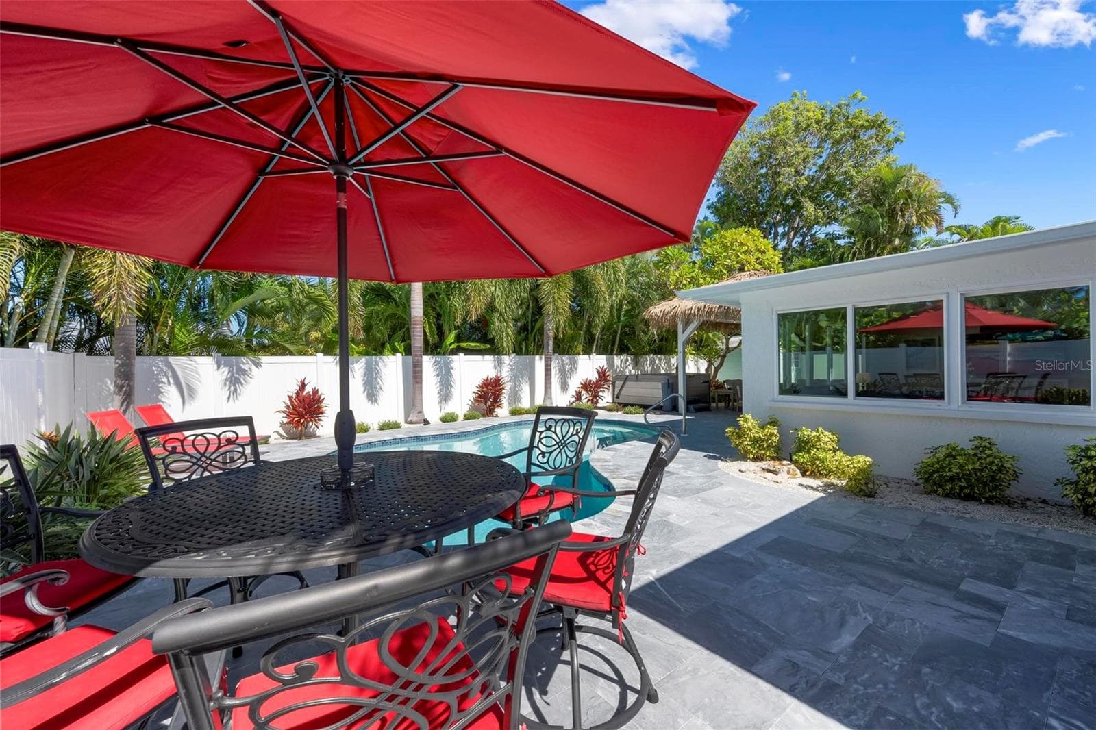 Pavered outdoor pool patio with heated saltwater pool and hot tub - 504 69TH ST, HOLMES BEACH
