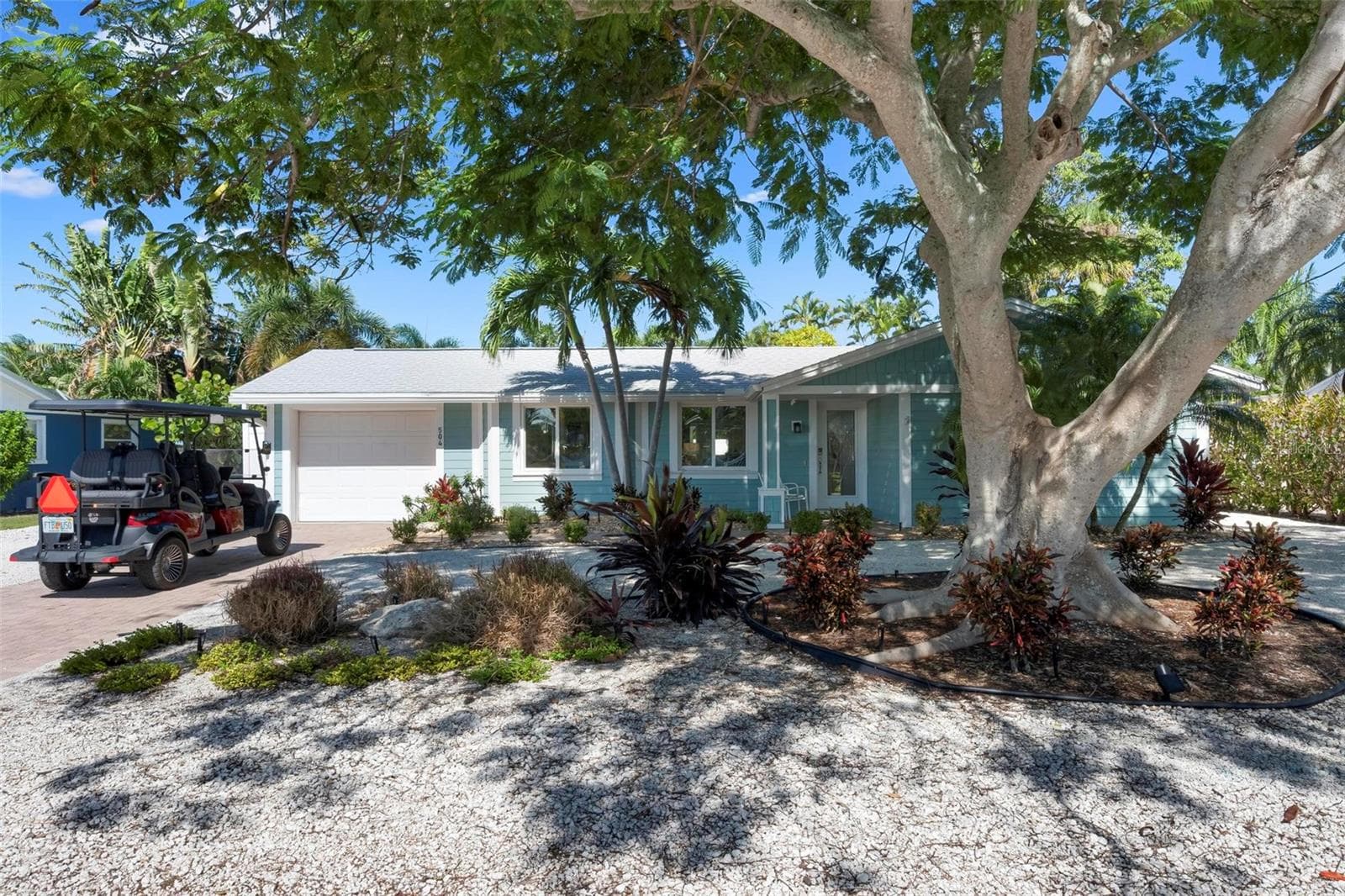 Front of home with beautiful poinciana tree - 504 69TH ST, HOLMES BEACH