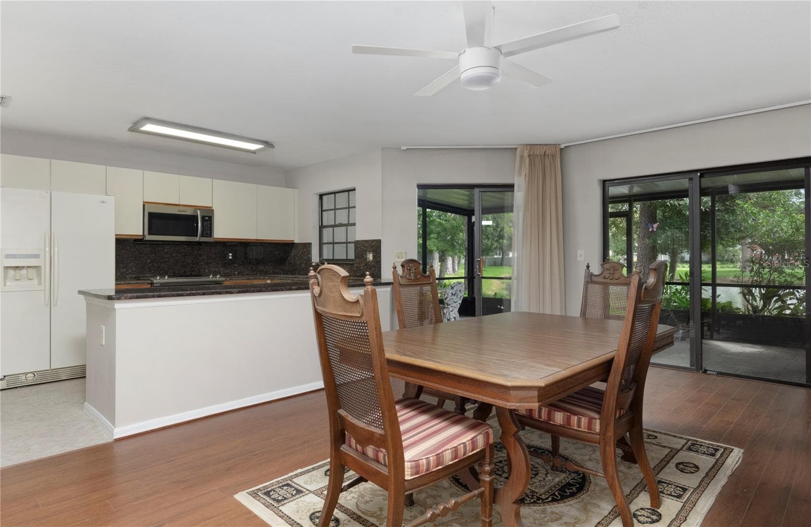 Dining room opens to porch and kitchen. - 1210 HOUNDS RUN, SAFETY HARBOR