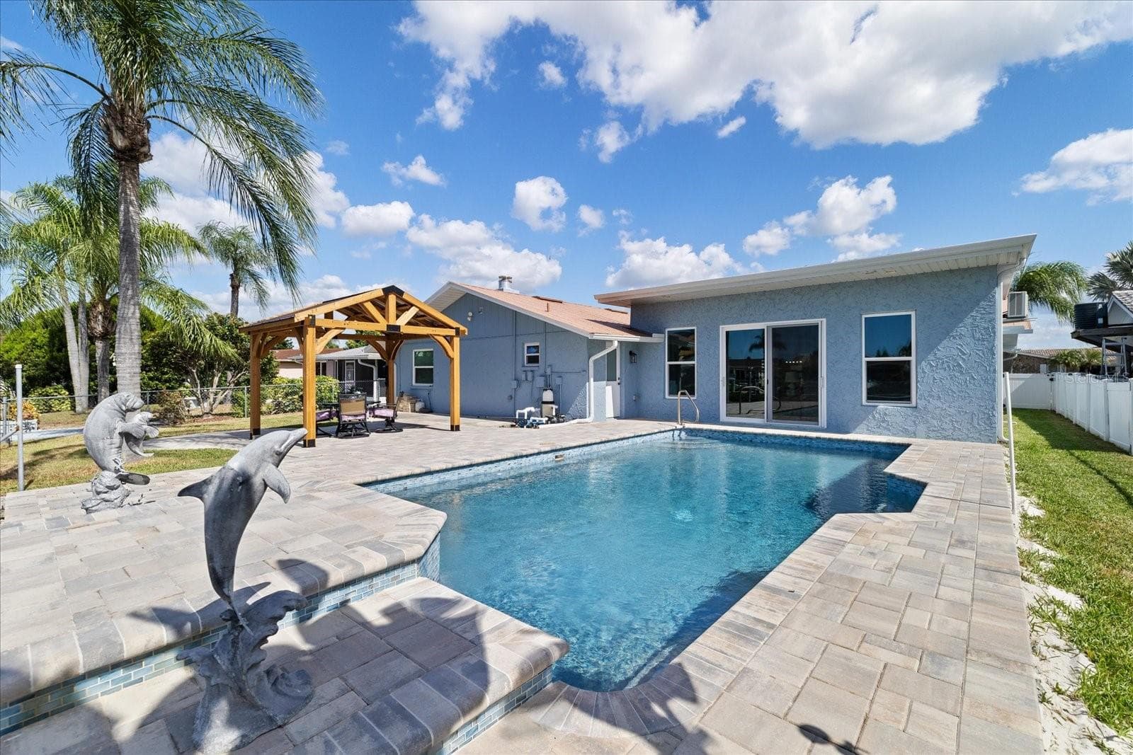 Dolphin statues on waterfall feature pool - 5001 MARLIN DR, NEW PORT RICHEY