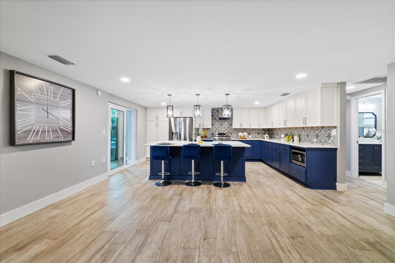 kitchen showing door to guest bedrooms and full bath and sliders to family room - 5001 MARLIN DR, NEW PORT RICHEY