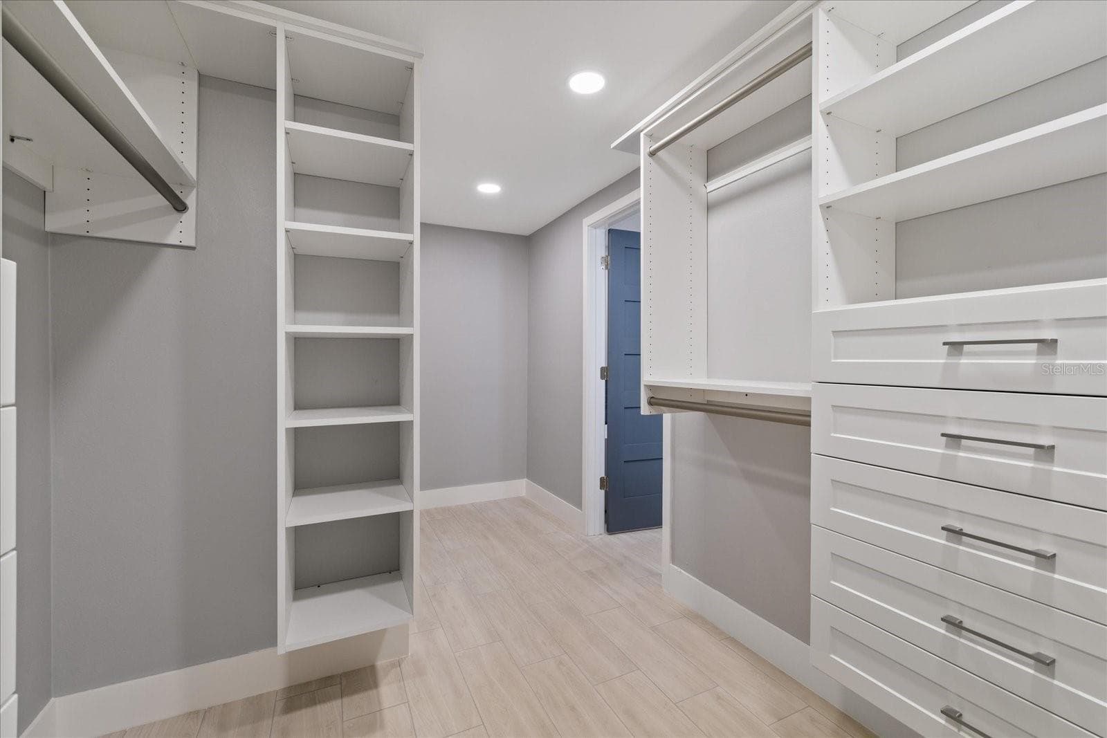 Looking toward doorway inside primary walk in closet - 5001 MARLIN DR, NEW PORT RICHEY