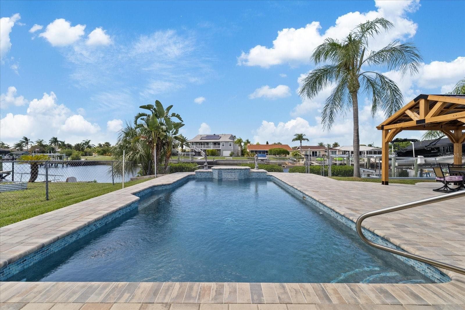 View to the water of pool and waterfall feature - 5001 MARLIN DR, NEW PORT RICHEY