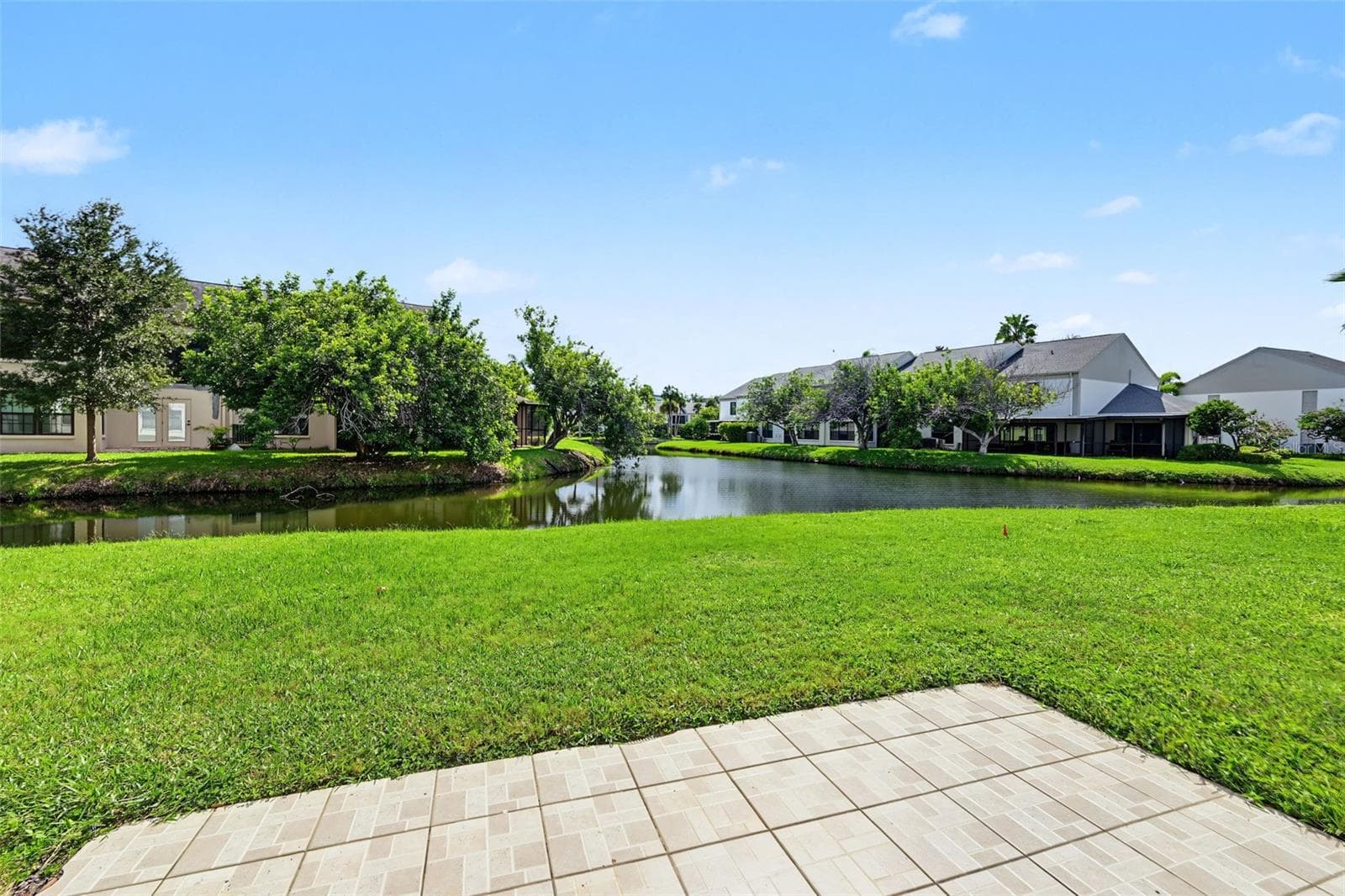 This 2 Bedroom, 2 Bath first floor condo has water views from the back sliders and both bedrooms providing natural light galore! - 2460 HERON TER #102E, CLEARWATER