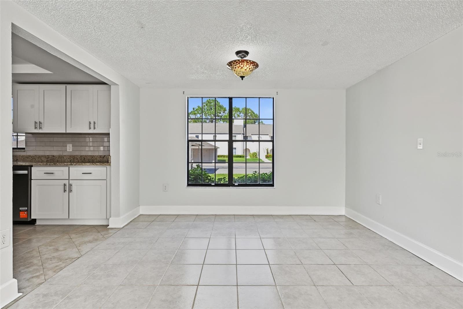 The Dining Area is just off the Kitchen and overlooks the Living Room. The windows truly provide significant natural light. - 2460 HERON TER #102E, CLEARWATER