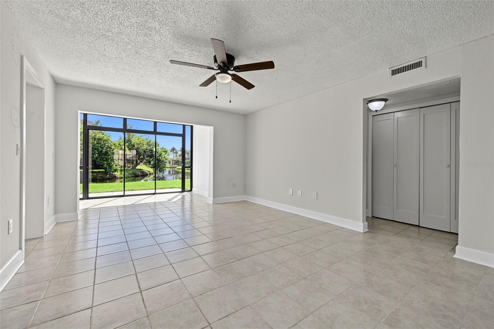 Living Room and Sunroom Angle - 2460 HERON TER #102E, CLEARWATER