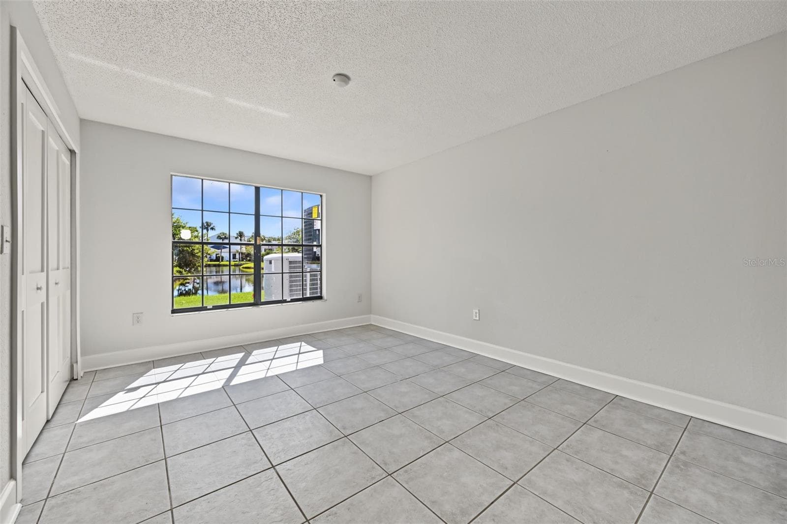 Bedroom Two also has views of the water and the hall bathroom is located just outside. - 2460 HERON TER #102E, CLEARWATER