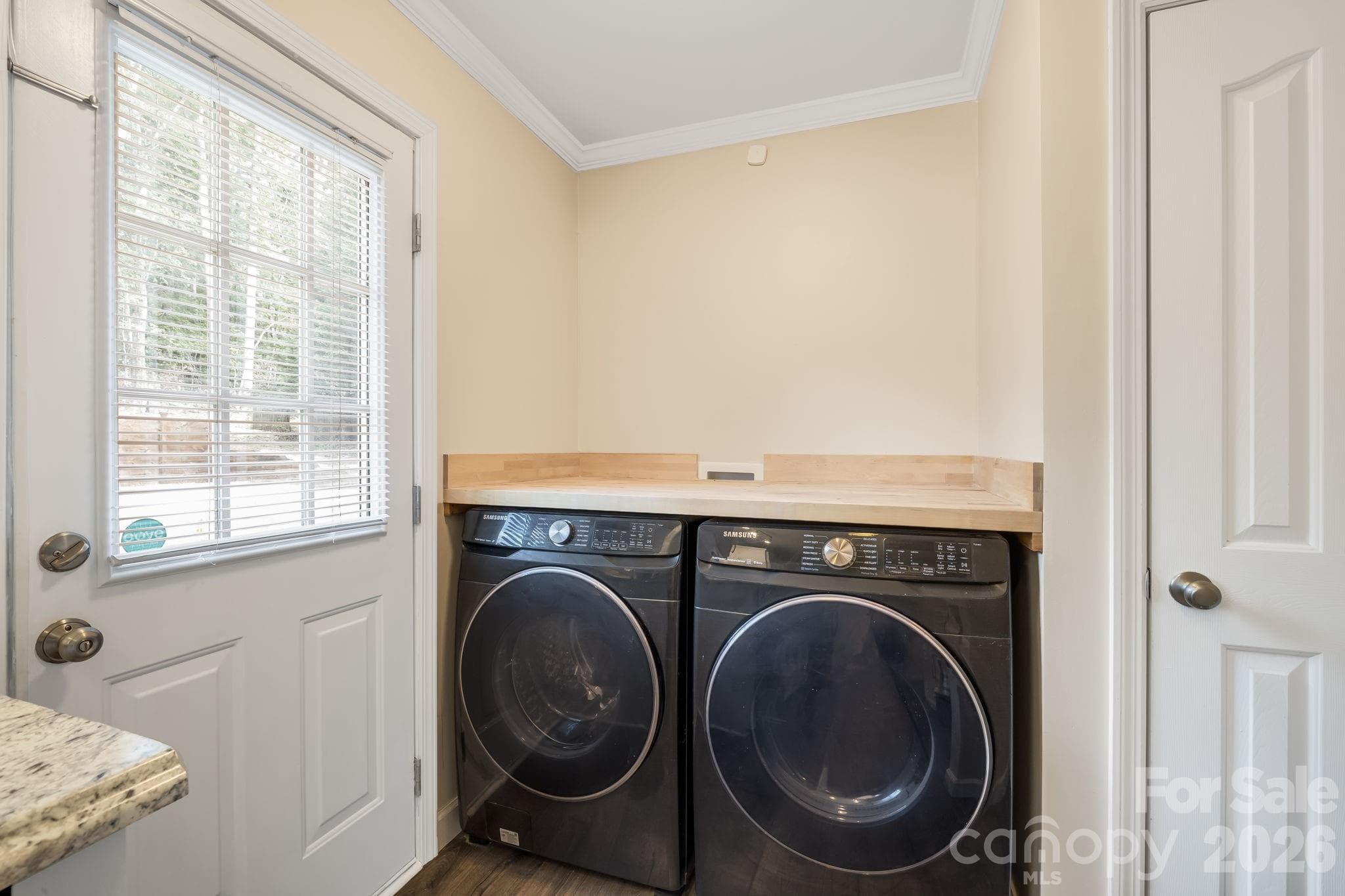 A convenient laundry area right off the kitchen keeps everyday tasks close at hand. - 710 Stoney Mountain Road, Hendersonville