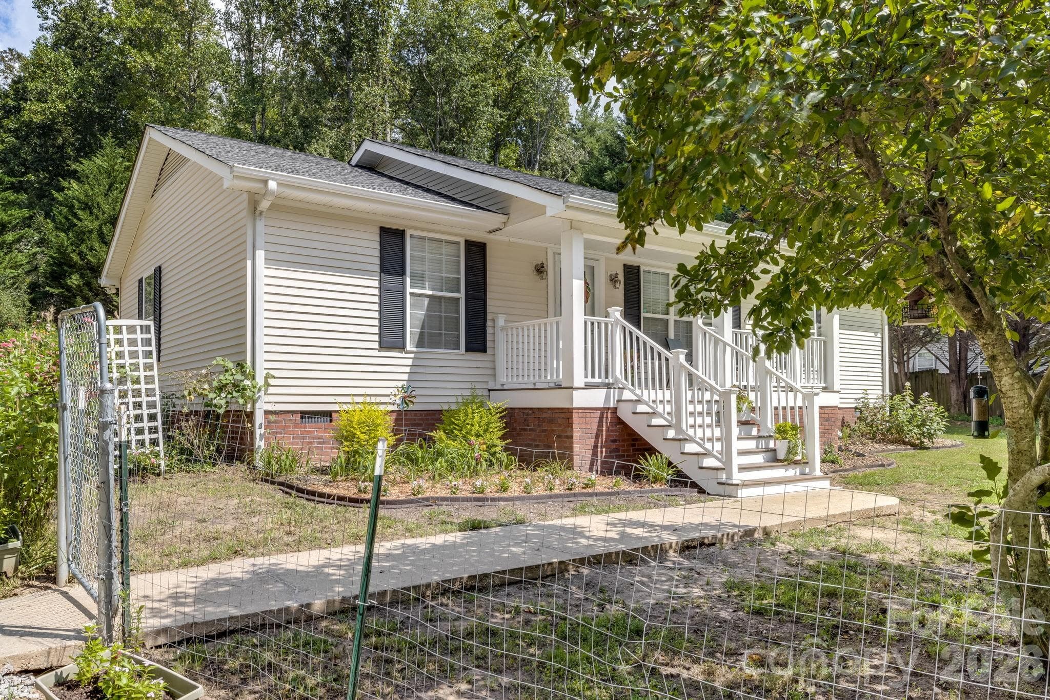 Can you picture coming home to this welcoming porch and a yard with room to enjoy? - 710 Stoney Mountain Road, Hendersonville