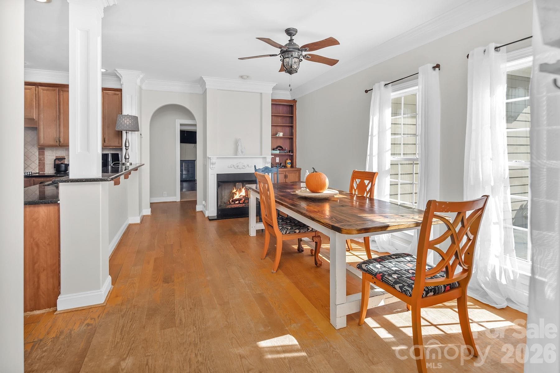 Fireplace in Kitchen virtually staged with a fire. - 5050 Shady Meadow Lane, Denver