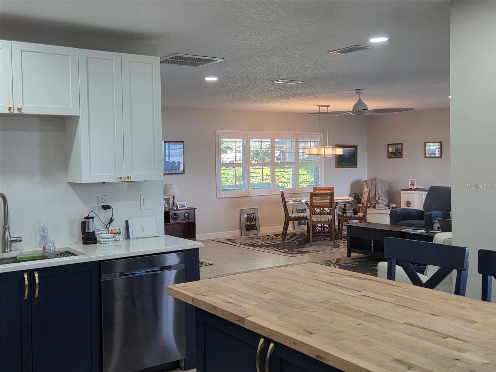 View of the great room and dining room from the kitchen - 2526 RUSK CT, DELTONA