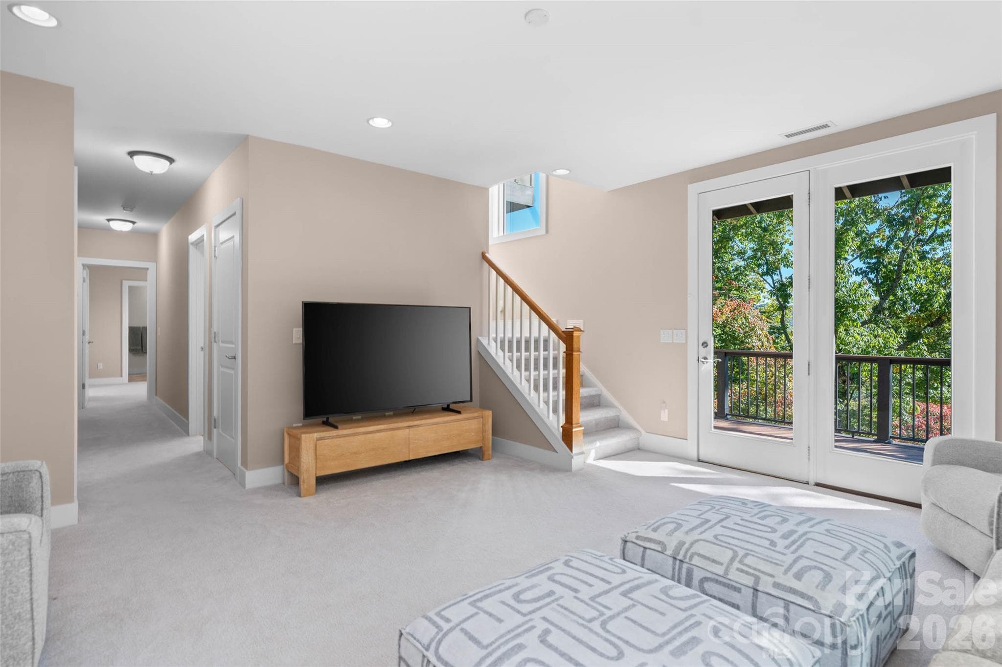 Lower level living/family room with direct access to a large deck with amazing views into town. - 351 Chapel Road, Black Mountain