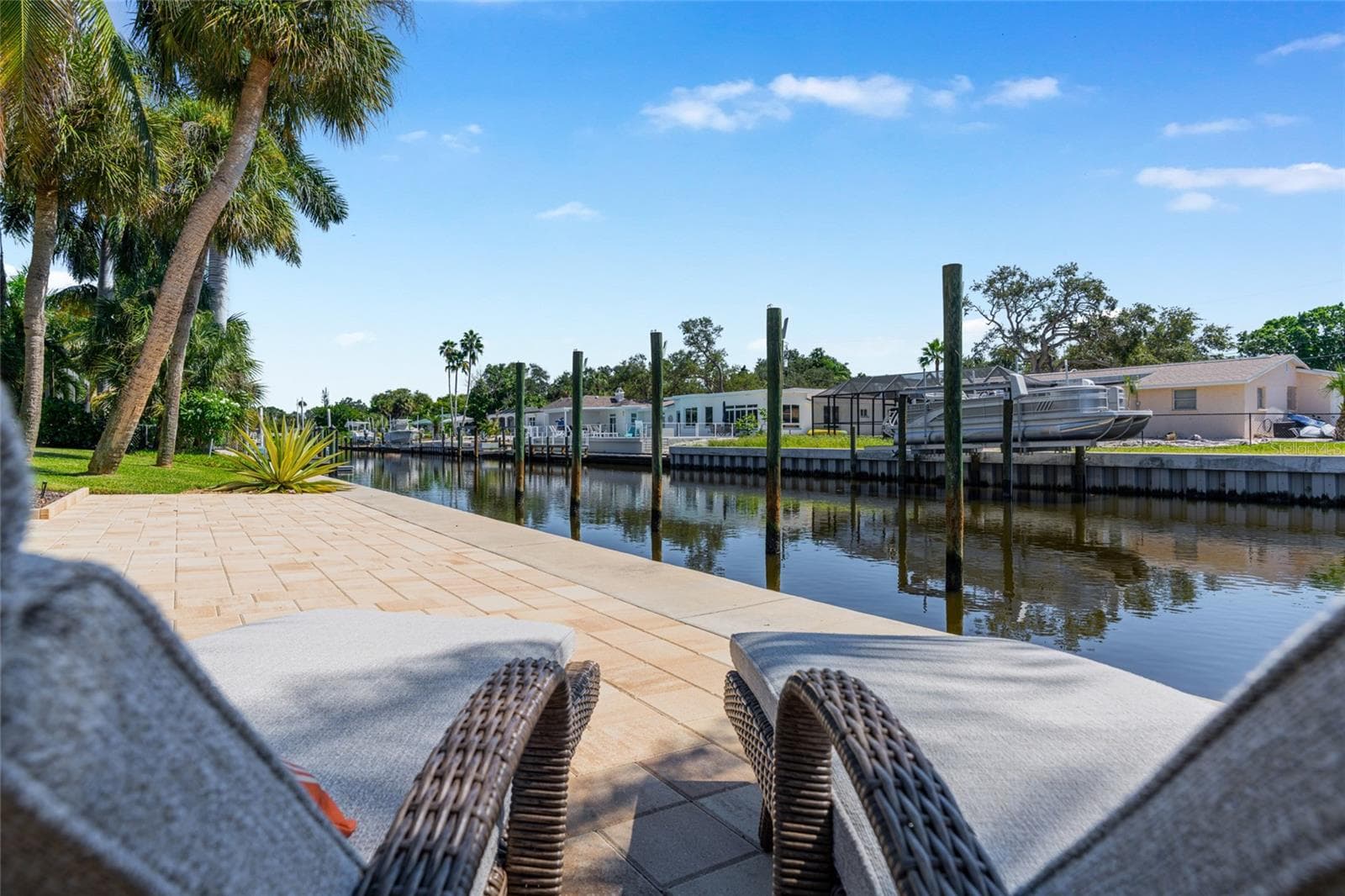 Waterfront Terrace Seating, highlighting the connection to the water and Siesta Key lifestyle. - 5376 SHADOW LAWN DR, SARASOTA