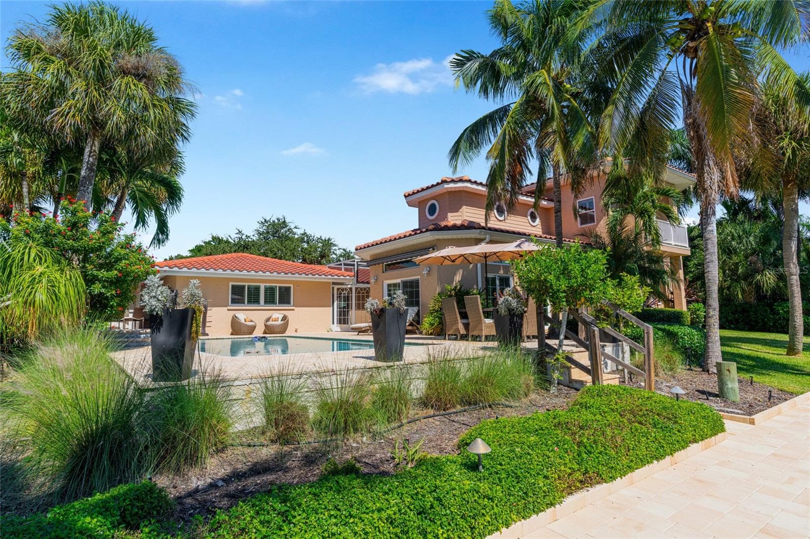 Rear Exterior Waterfront, highlighting the connection to the water and Siesta Key lifestyle. - 5376 SHADOW LAWN DR, SARASOTA