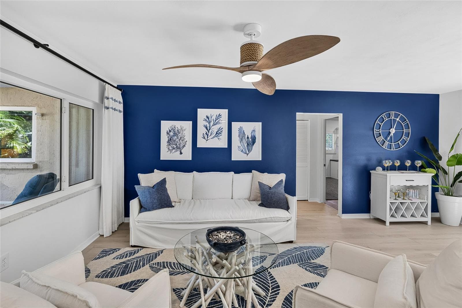 Living Room Blue Accent Wall, with an easy flow for everyday living and entertaining. - 5376 SHADOW LAWN DR, SARASOTA