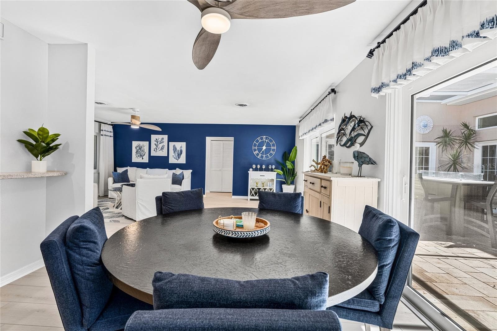 Dining area overlooks the screened courtyard lanai, creating an easy connection between indoor and outdoor living. - 5376 SHADOW LAWN DR, SARASOTA