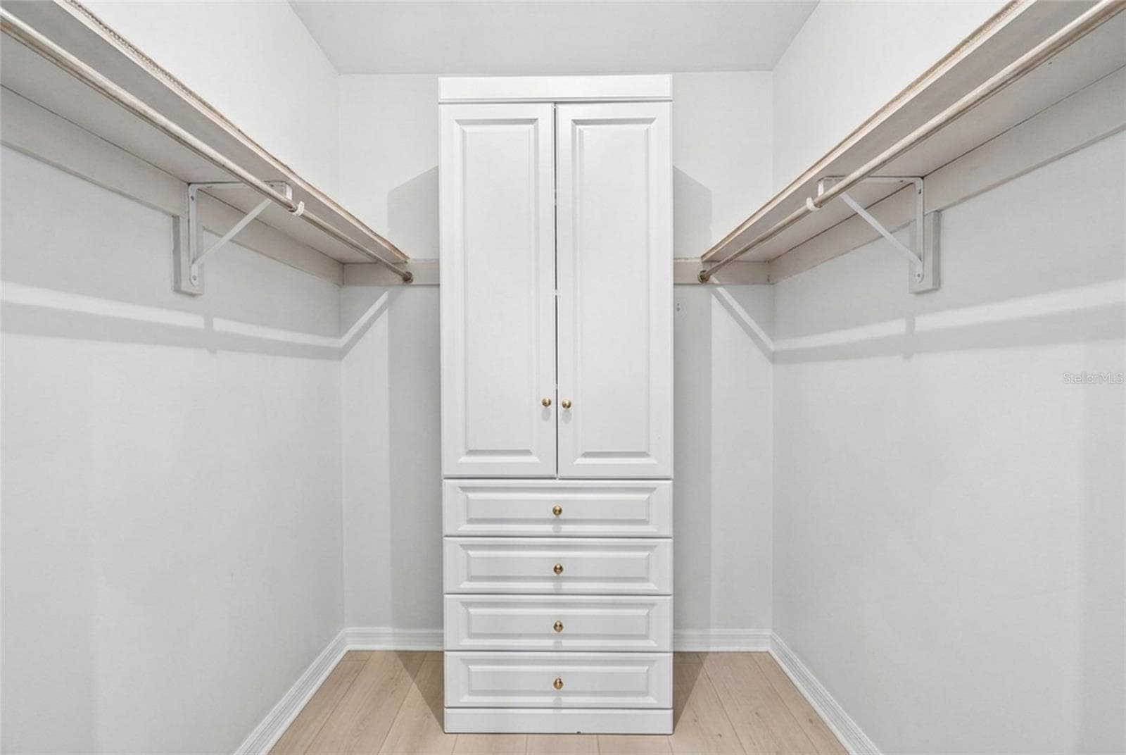 Walk in storage complements the first floor primary suite, which includes two walk in closets. - 5376 SHADOW LAWN DR, SARASOTA
