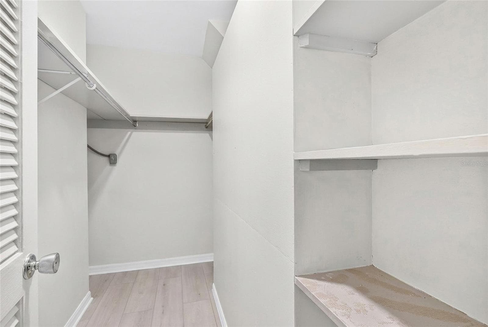 The first floor primary suite includes two walk in closets, providing generous storage. - 5376 SHADOW LAWN DR, SARASOTA