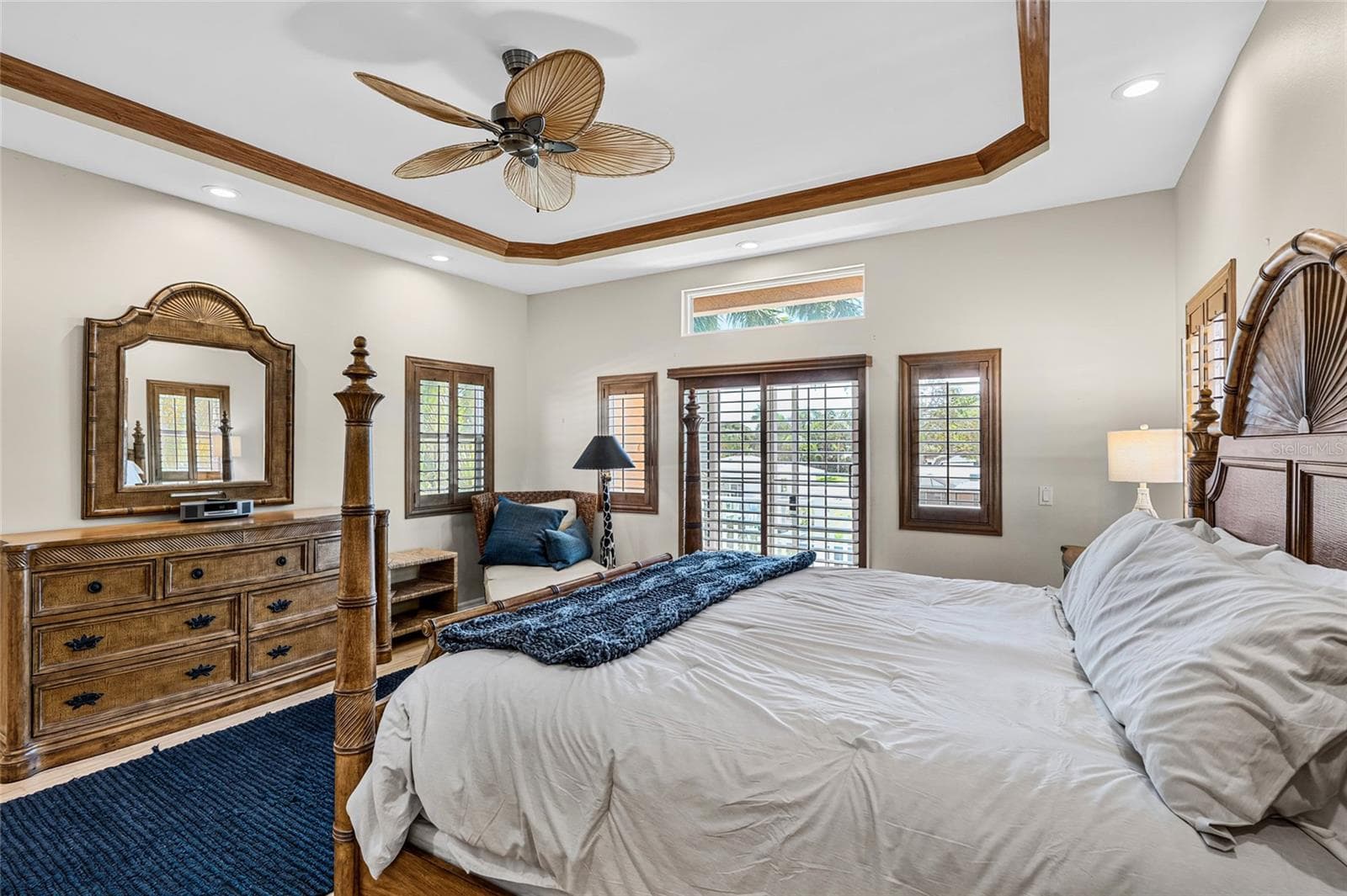 Wide view of the second floor primary suite, a private upper level retreat with canal views and balcony access. - 5376 SHADOW LAWN DR, SARASOTA