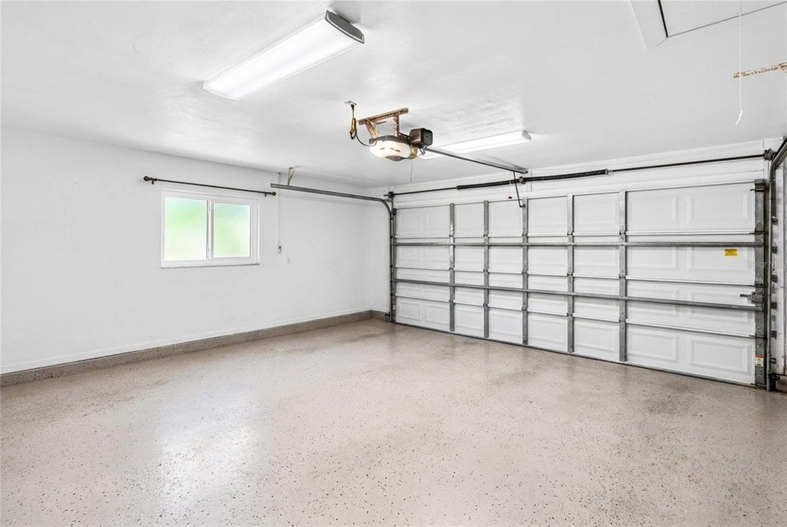 Two Car Garage, adding useful function and storage. - 5376 SHADOW LAWN DR, SARASOTA