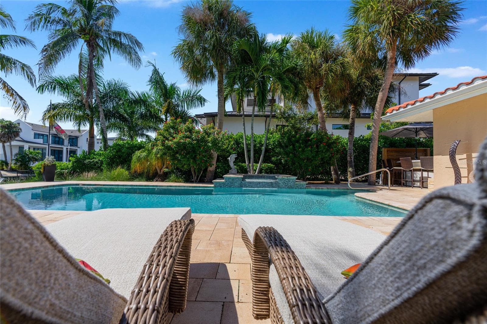 Pool Seating View, creating an inviting setting for relaxing and entertaining. - 5376 SHADOW LAWN DR, SARASOTA
