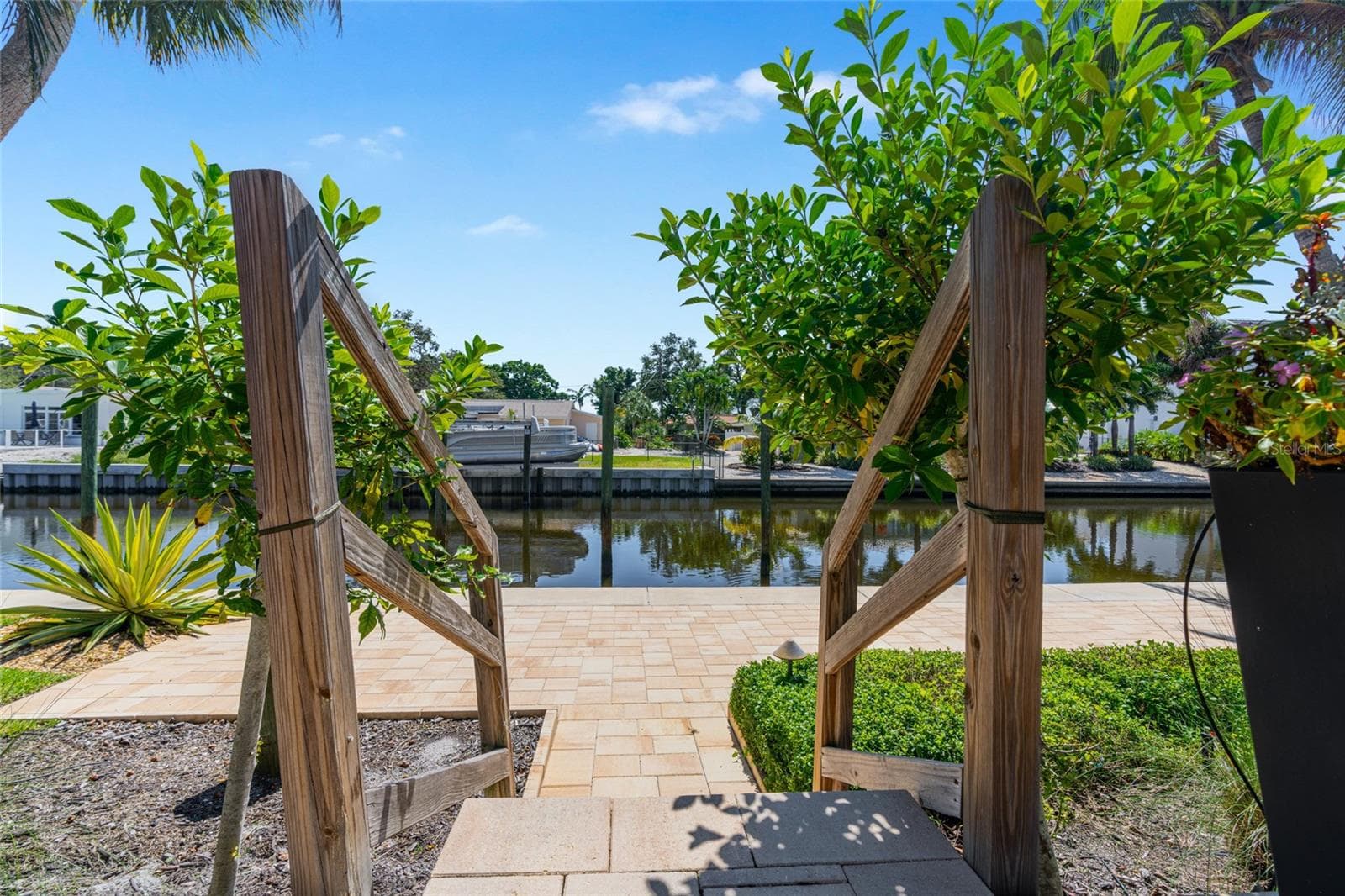 Waterfront Terrace Twilight, highlighting the connection to the water and Siesta Key lifestyle. - 5376 SHADOW LAWN DR, SARASOTA