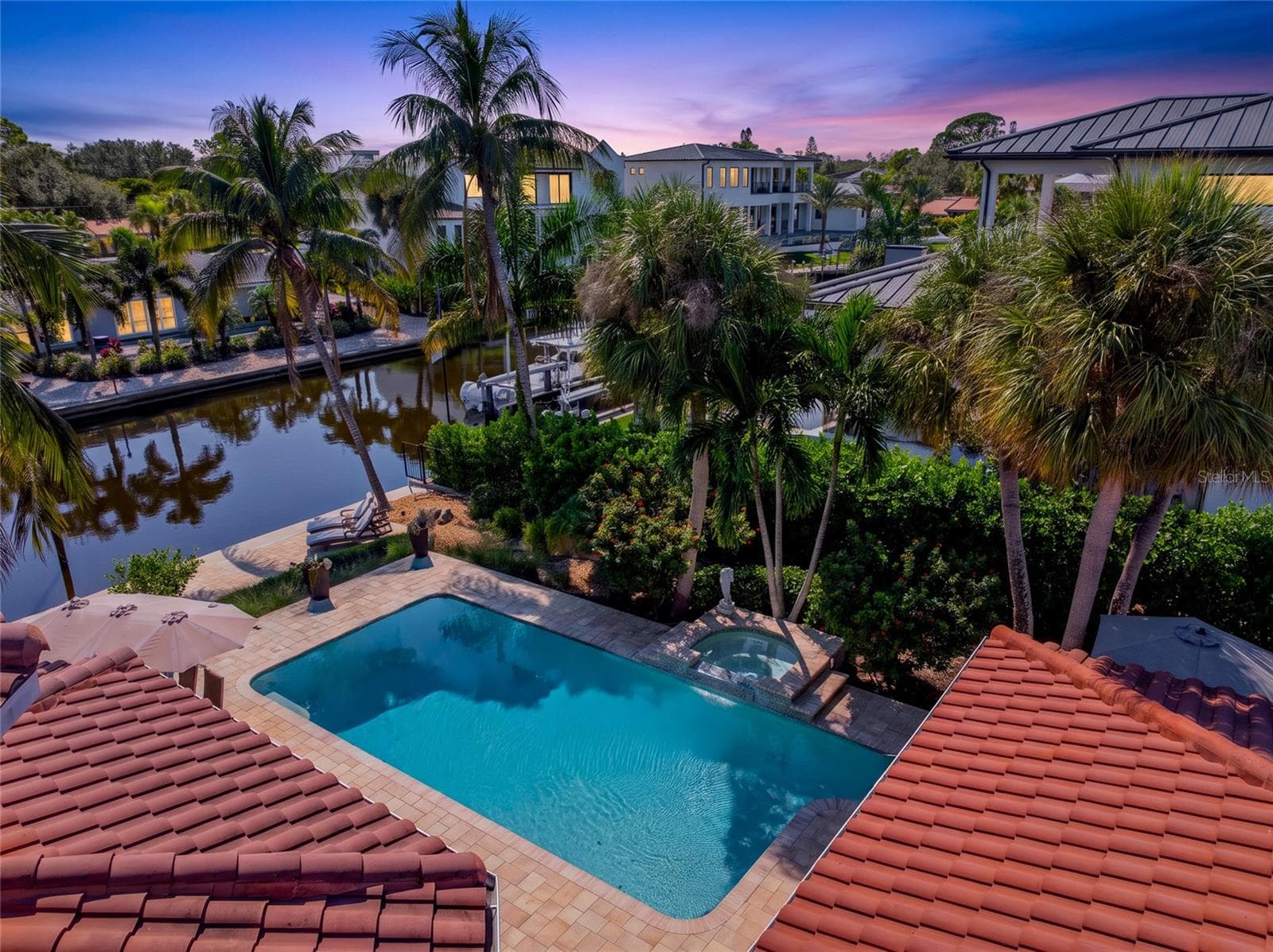 Pool Aerial Twilight, creating an inviting setting for relaxing and entertaining. - 5376 SHADOW LAWN DR, SARASOTA
