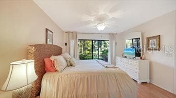 Primary Bedroom with Sliders to the Lanai overlooking the Lake - 5326 LAKE ARROWHEAD TRL #7, SARASOTA