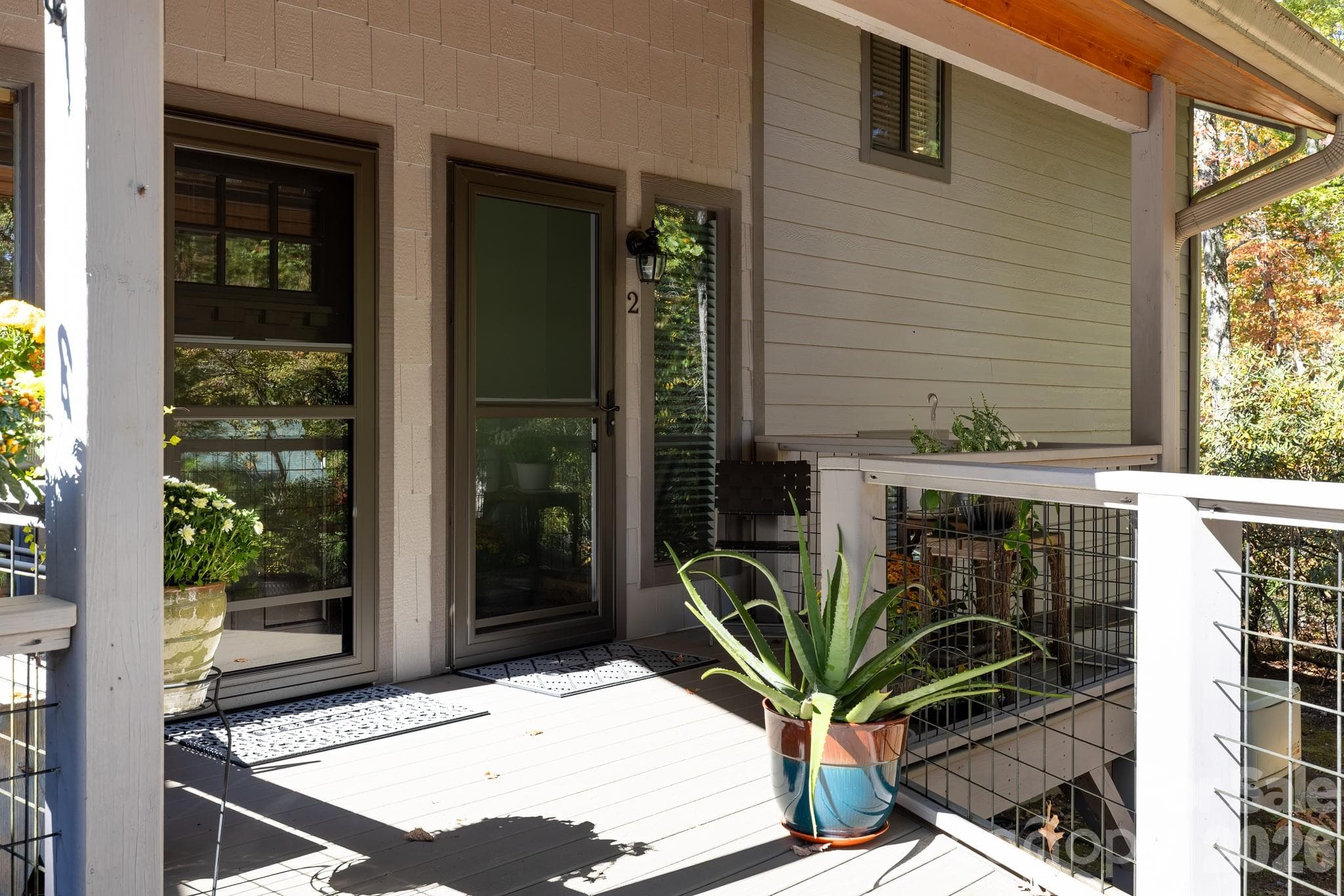 Close-up of the private covered entrance, featuring attractive wood railings and easy access from the parking area. - 524 Three Mile Knob Road, Pisgah Forest